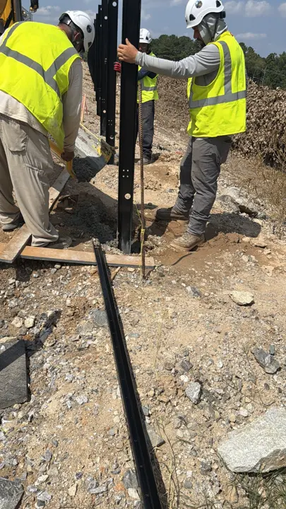 ATL Metal Fab crew setting a fence post